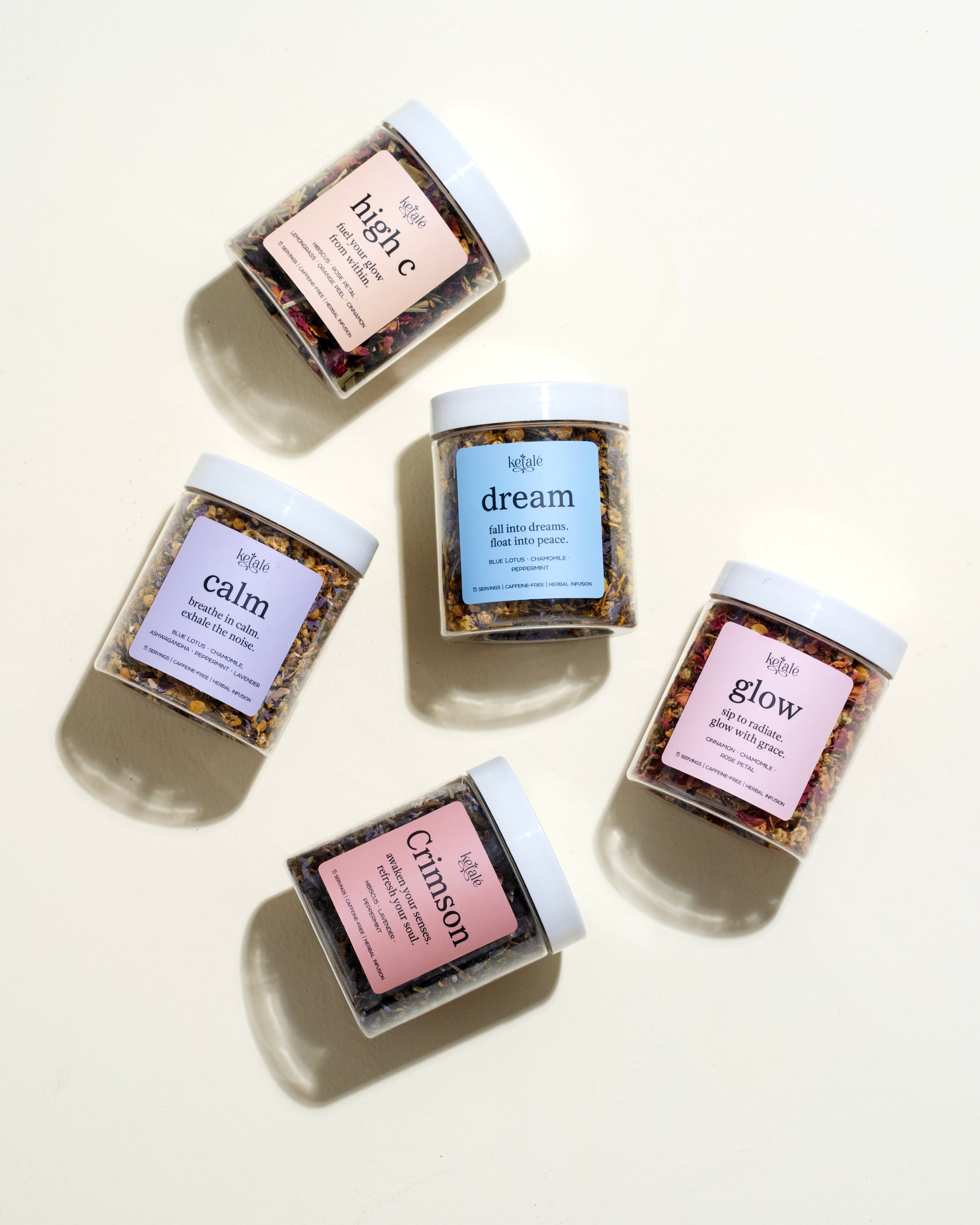 The image features five pastel-labeled jars of herbal tea blends from Ketale, each promoting wellness with unique ingredients and calming taglines. Arranged artfully on a cream background, the teas evoke themes of serenity, radiance, and inner peace.